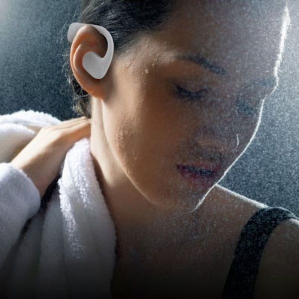 Woman wearing T'nB ENERGY Air Open Ear headphones